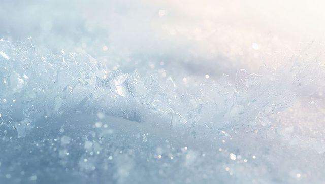 Sunlit ice crystal ridge on snow with sparkling bokeh and delicate frost texture