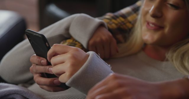 Smiling Woman Relaxing and Lounging with Smartphone at Home - Download Free Stock Images Pikwizard.com