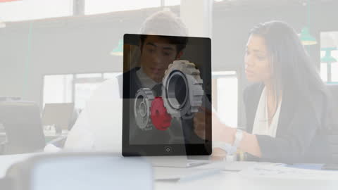 Business Team Examines Digital Gear Interface Display