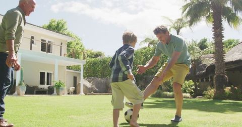 Multi-Generational Family Enjoying Soccer in Backyard Oasis