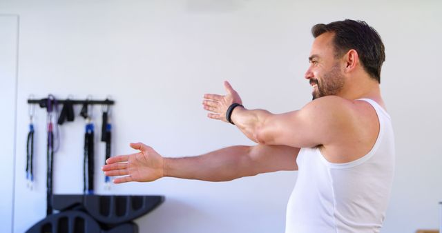 Caucasian Man Stretching Indoor for Fitness and Well-being - Download Free Stock Images Pikwizard.com