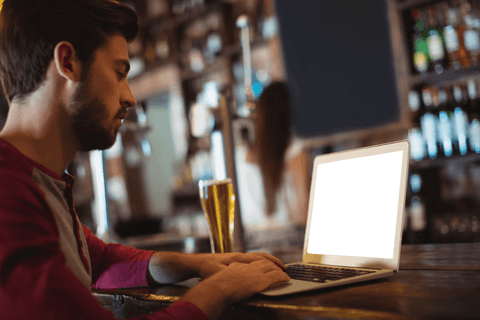 man browsing laptop at bar counter with transparent screen - Download Free Stock Videos Pikwizard.com