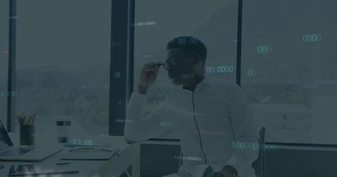 Business Professional Adjusting Glasses Sitting in Modern Office