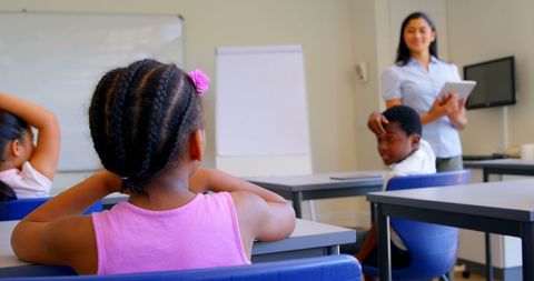 Teacher Engaging Young Students in Modern Classroom Setting