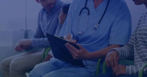 Nurse writing patient notes on clipboard in clinic waiting room with stethoscope