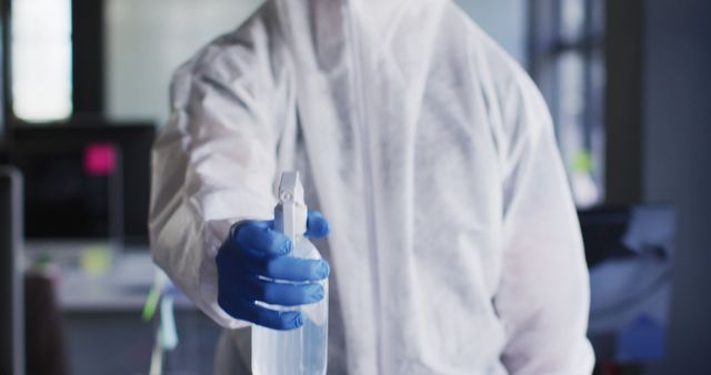 Technician in Hazmat Suit Disinfecting Office with Spray Bottle - Download Free Stock Images Pikwizard.com