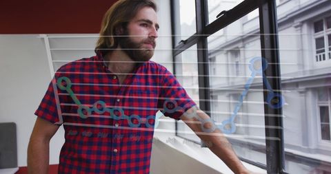 Young Professional Gazing Out Office Window with Business Graph Overlay - Download Free Stock Images Pikwizard.com