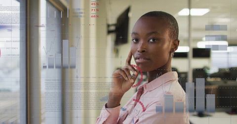 Businesswoman Analyzing Financial Data and Graphs in Office