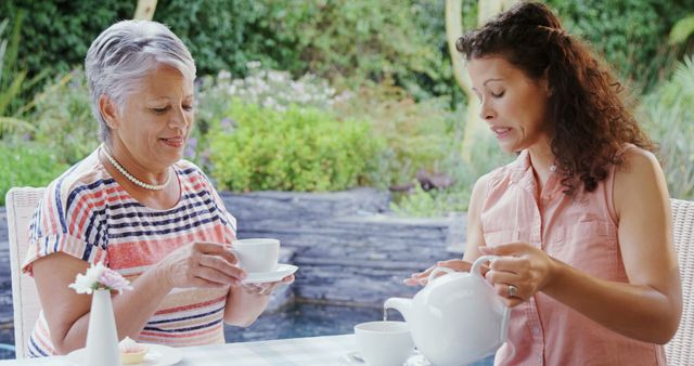 Smiling Older Woman and Young Woman Drinking Tea Outdoors - Download Free Stock Photos Pikwizard.com