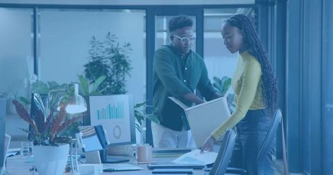 Collaborative Office Team Reviewing Analytics and Reports in Modern Minimalist Workspace