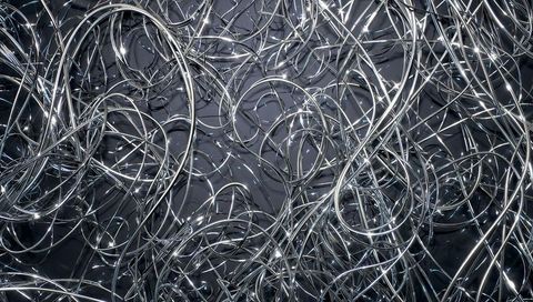 Intertwining silver loops and wires creating abstract pattern