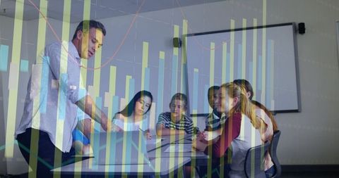 Teacher Leaning Over Laptop Guiding Students Through Data Presentation and Collaboration