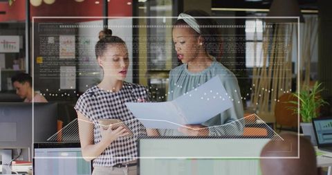 Collaborating Professionals Discussing Data in Tech Office