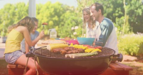 Family Enjoying Barbecue on Sunny Day in Cozy Garden - Download Free Stock Images Pikwizard.com