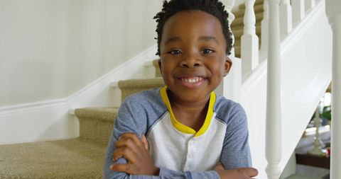Happy African American Boy Smiling on Home Staircase - Download Free Stock Images Pikwizard.com