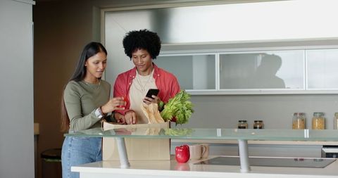 Couple Unpacking Groceries in Contemporary Kitchen