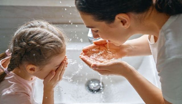 Mother and Daughter Washing Faces at Sink, Teaching Healthy Hygiene and Bonding Moment