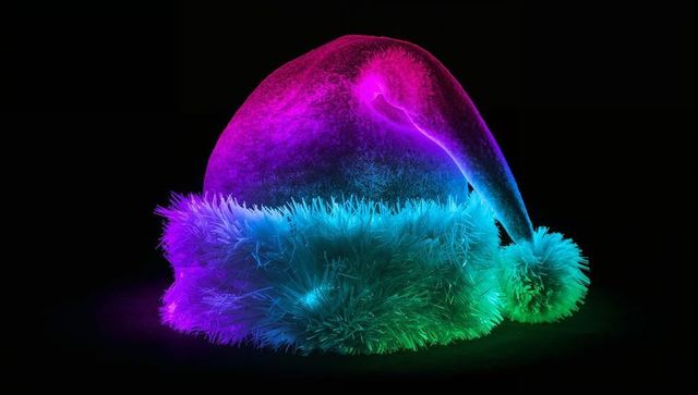 Glowing neon santa hat with iridescent faux-fur trim and pom pom, magenta-to-teal gradient
