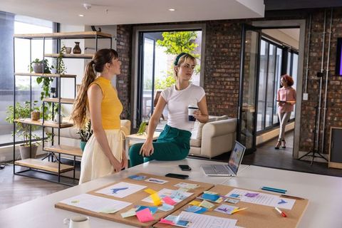 Creative Team Discussion on Design Layouts in Stylish Office