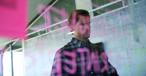 Contemplative Man Sealed Behind Pink Graffiti on Glass Wall - Download Free Stock Images Pikwizard.com