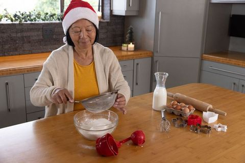 Senior Woman Baking Festive Cookies at Home During Christmas