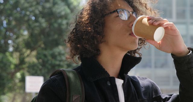 Young Man Drinking Coffee Outdoors in Park - Download Free Stock Images Pikwizard.com