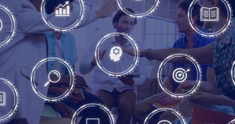 Diverse team collaborating in meeting with digital business icons and strategy overlay