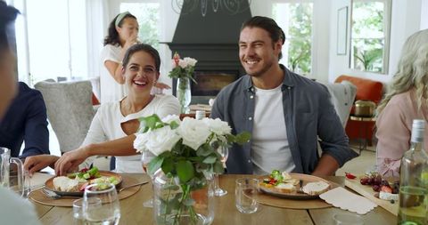 Friends dining and socializing with joyful laughter