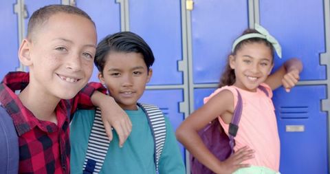 Multiracial School Friends Smiling Near Lockers