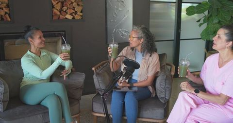 Multigenerational women hosting cozy wellness podcast with green smoothies and conversation