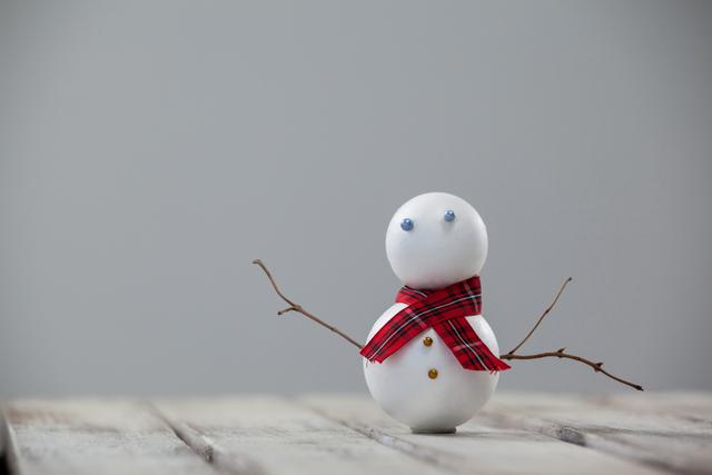Snowman on a wooden plank