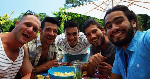 Group of Friends Enjoying Outdoor Barbecue Party