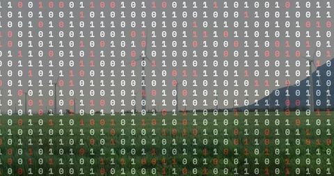 Binary code overlay on windfarm meadow visualizing renewable energy data and smart grid