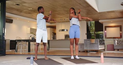 Couple Enjoying Morning Fitness Routine on Modern Patio