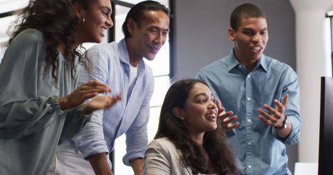 Happy multiracial team celebrating success in office environment