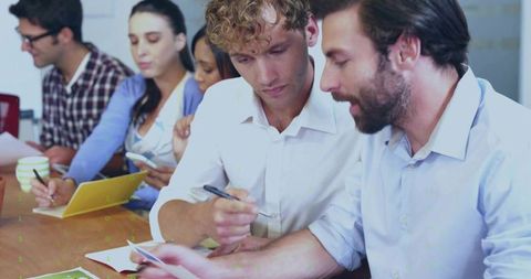 Men collaborating in office discussion meeting room