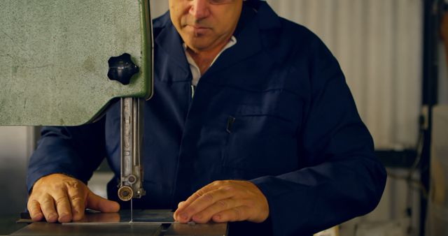 Mature carpenter using a bandsaw machine in a workshop, focusing on craftsmanship and precision. Ideal for articles or materials on woodworking, manual labor, and industrial settings.