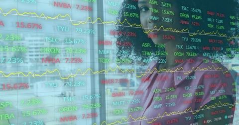 African American Woman Analyzing Financial Data Display in Modern Office