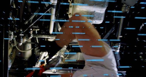 Aircraft mechanic tightening hydraulic actuator undercarriage with blue data light streaks