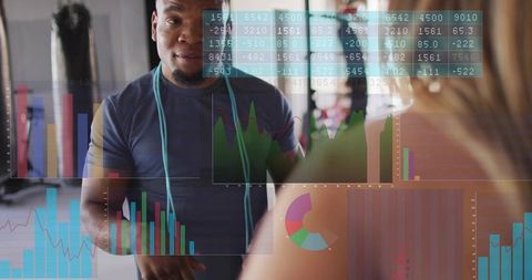 Male trainer gesturing explaining fitness metrics with hud charts and client interaction