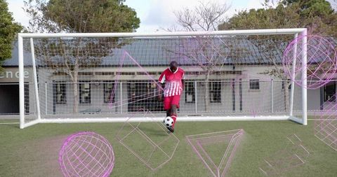Dribbling soccer player in red white jersey inside goal with magenta wireframe overlays