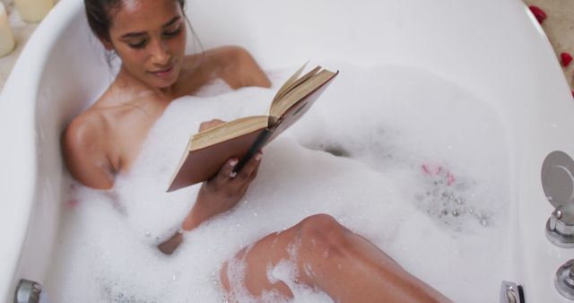 Woman Relaxing in Bathtub Reading Book Surrounded by Bubbles - Download Free Stock Images Pikwizard.com