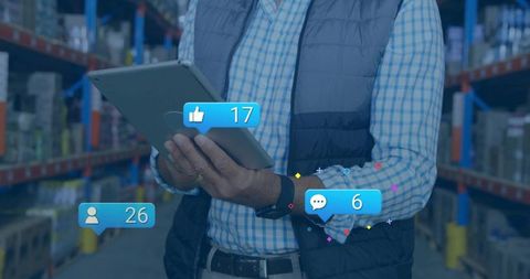 Warehouse manager holding tablet scanning inventory with social analytics overlays