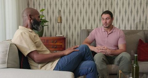 Thoughtful Conversation Between Friends in Cozy Living Room