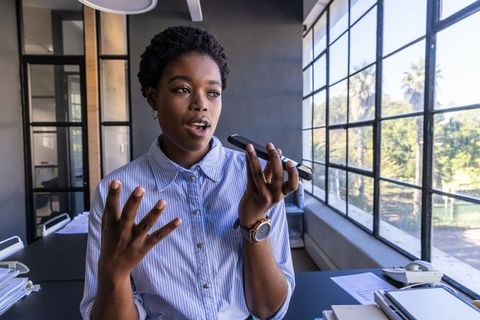 Professional African American Woman Having Phone Call in Sleek Modern Office