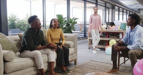 Office birthday celebration with colleagues smiling and happy