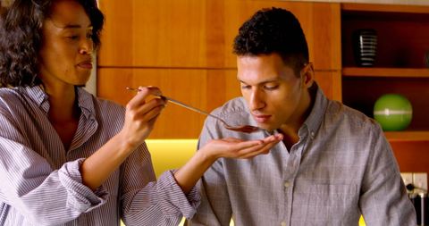 Couple Tasting Food Together in Cozy Home Kitchen