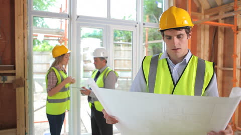 Construction Site Architect Analyzing Plans with Team Discussion