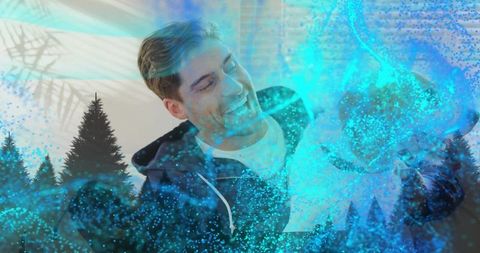 Smiling man cradling puppy with teal particle overlay and evergreen double exposure
