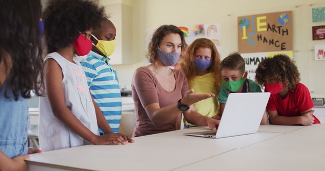 Teacher with Diversity of Children Browsing Laptop, All Wearing Colorful Face Masks - Download Free Stock Images Pikwizard.com